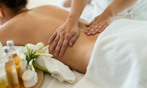 Young beautiful Asian woman sleep relaxing in the Oil spa massage in salon. Select focus hand of masseuse